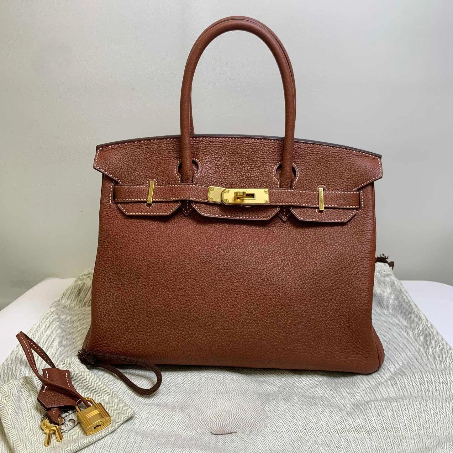 Litchi-grain leather lock bag